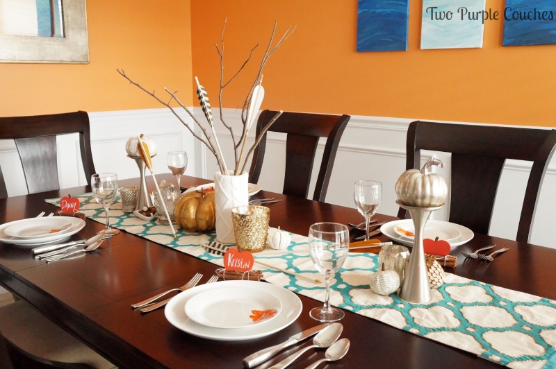 Bright oranges and teals are balanced with neutrals and glam metallics to create this bright and bold Thanksgiving tablescape. via www.twopurplecouches.com