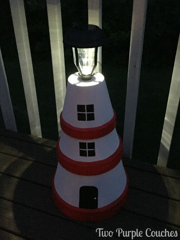 Light up the night with a solar lantern atop this clay pot lighthouse garden art. via www.twopurplecouches.com