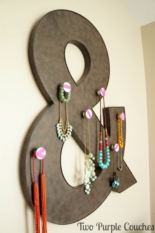 Perfect for space-saving! Turn metal wall decor into a spot to display your favorite jewelry! via www.twopurplecouches.com