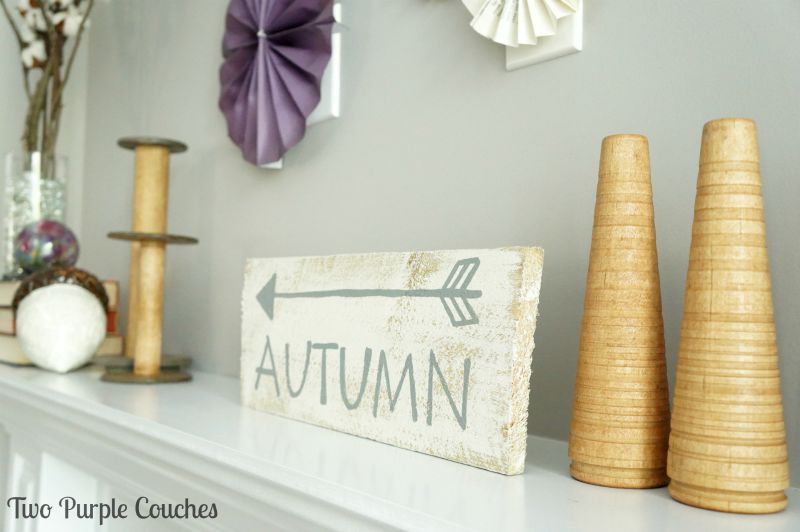 Light and natural wood tones paired with purples create a bright and non-traditional Fall Mantel. via www.twopurplecouches.com