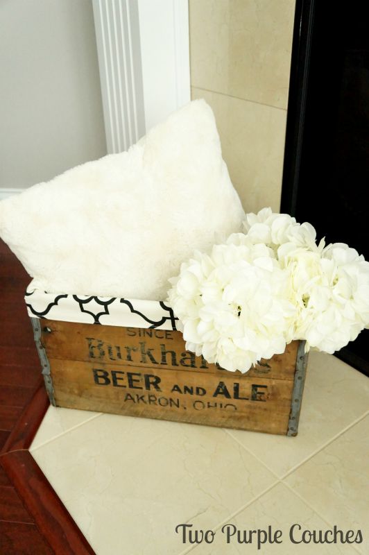 Vintage wood beer crates make beautiful home accents. Use them to stash extra throw pillows, blankets, magazines and more! via www.twopurplecouches.com