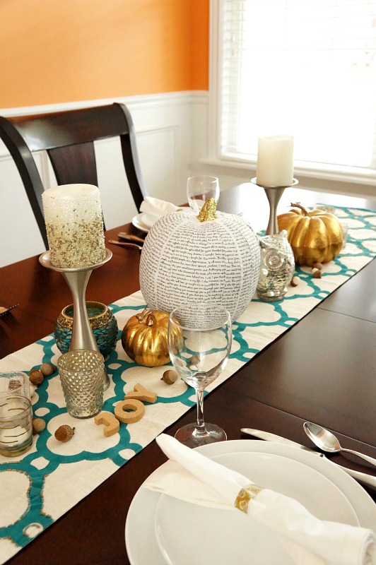A personalized book page covered pumpkin creates a special gratitude-filled centerpiece for Thanksgiving
