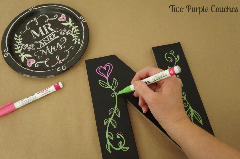Add flourishes to a chalkboard-style monogram using a paint pen.