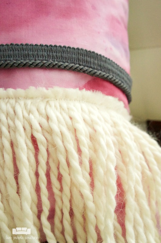 Yarn fringe detail on DIY boho pillow.