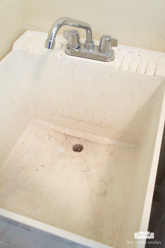 Laundry Room - builder grade utility tub stained with paint splatters