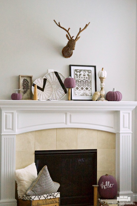Fall mantel decorations get a modern, tribal inspired makeover with simple neutral accents and colorful purple pumpkins. Try these DIY ideas in your home!