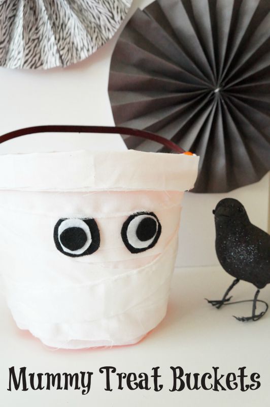 Send your trick-or-treaters off with these adorable DIY Mummy Treat Buckets. This easy Halloween project can be made with just a few simple supplies!