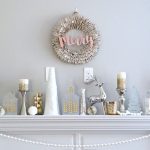 This Christmas mantel decor creates a gorgeous, elegant look with neutral metallics using a beautiful blend of white, silver, gold and mercury glass.