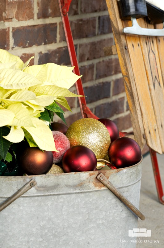 Love this idea! Add poinsettias and plastic ornaments to a galvanized bin to display on your holiday front porch!