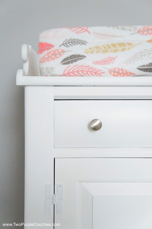 Repurpose an old cabinet into a functional changing table. Fresh new paint and updated hardware give it a modern look.