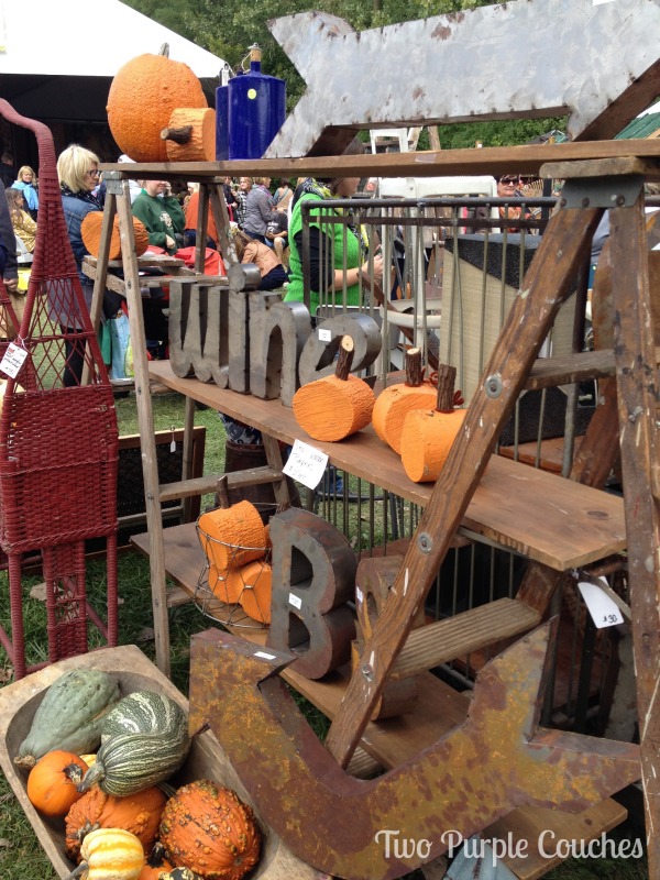 Neat vendor booth with wood slice pumpkins at the Country Living Fair in Columbus Ohio. via www.twopurplecouches.com #CLFair #CountryLiving #Fall #Fairs #columbus #ohio #pumpkins