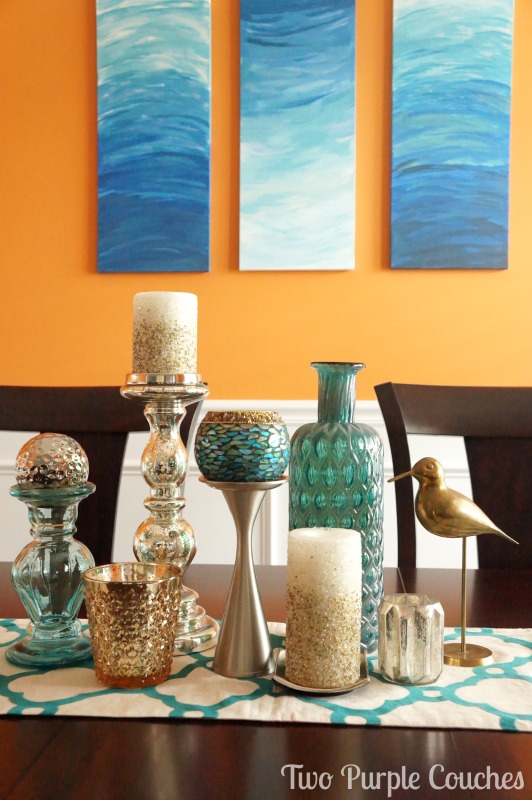 Bold orange and teal dining room decor and accessories. via www.twopurplecouches.com #homedecor #diningroom #orange #teal #color