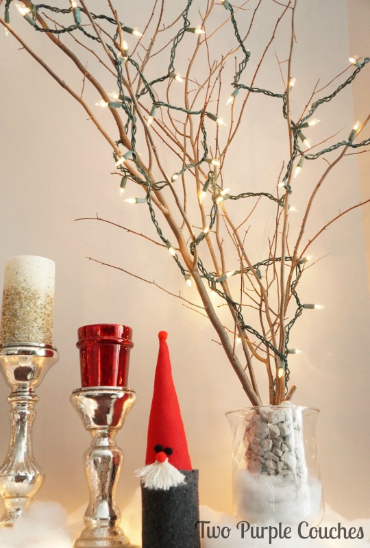 Lit Branches add warmth to a beautiful holiday mantel. via www.twopurplecouches.com