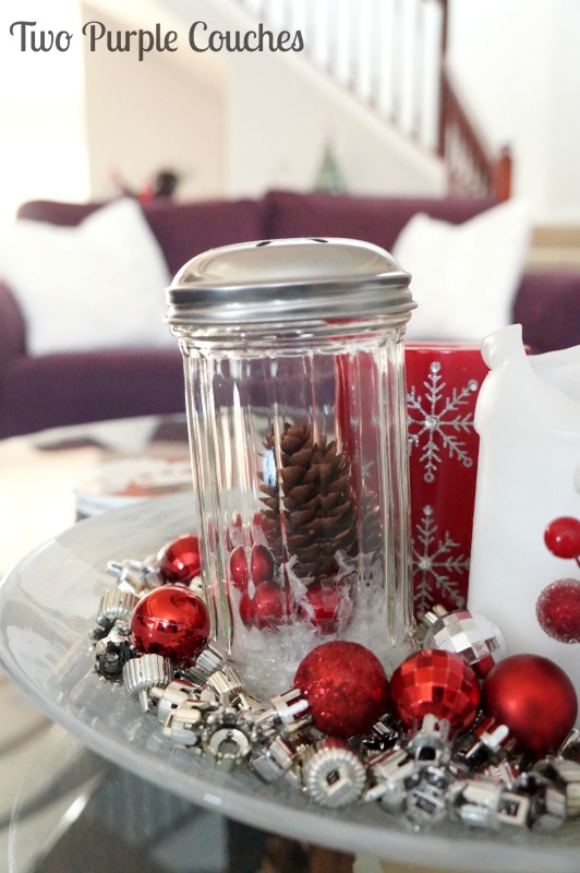 Pretty glass jar snow scenes make a great centerpiece paired with candles, ornaments and ornament caps! via www.twopurplecouches.com