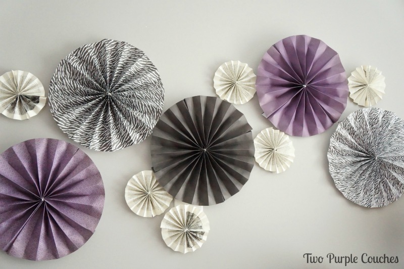 Paper Pinwheel Wall Collage via www.twopurplecouches.com