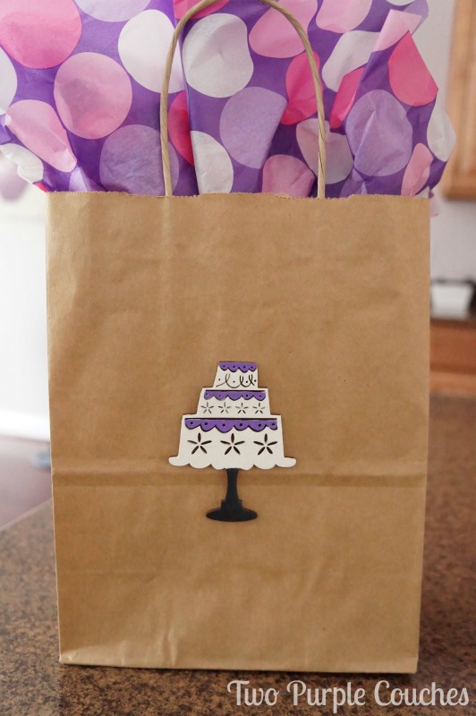 Create your own gift bags with wood embellishments. DIY Birthday Gift Bag via www.twopurplecouches.com