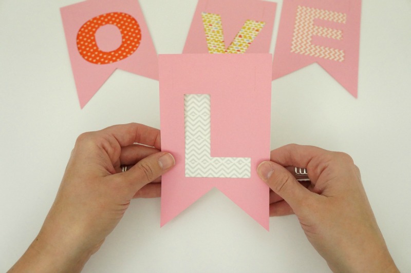 layering washi tape and construction paper banner