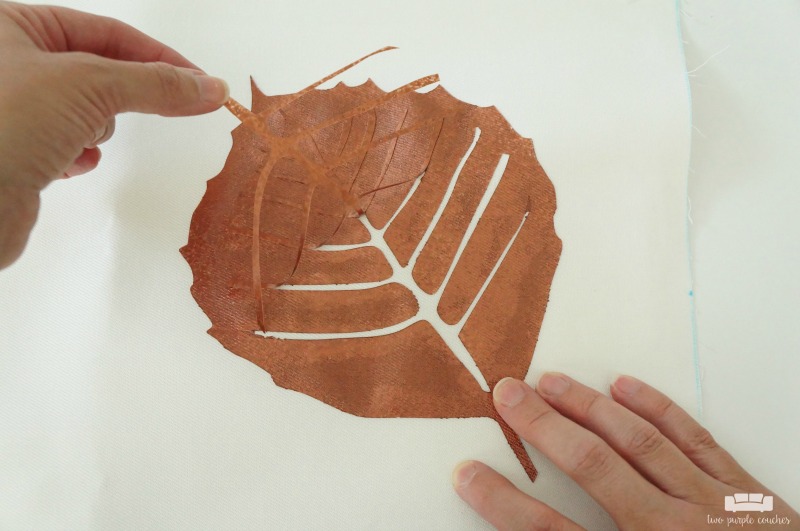 Learn how to use your cutting machine to create a stencil and create this fall leaf throw pillow! An easy way to update throw pillows for each season!