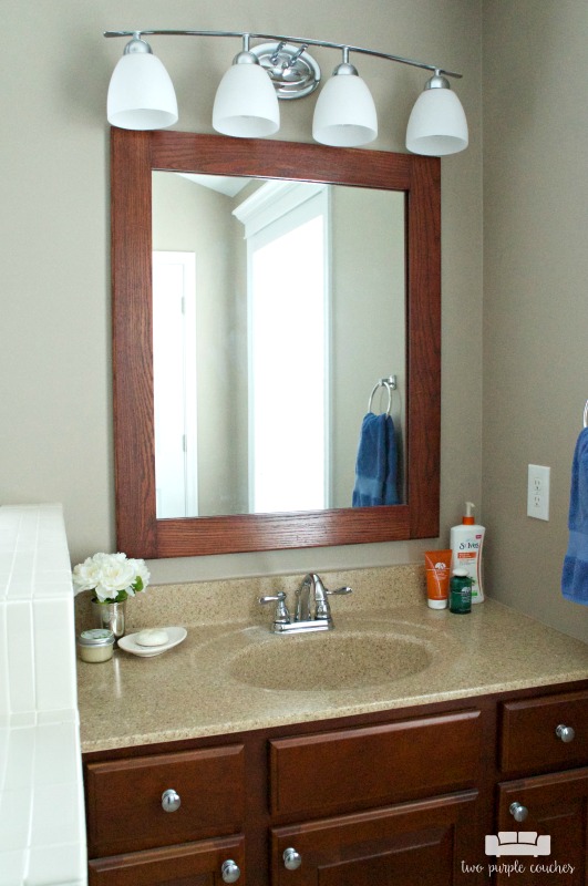 Master Bath vanity area with DIY framed mirror and updated vanity lights.