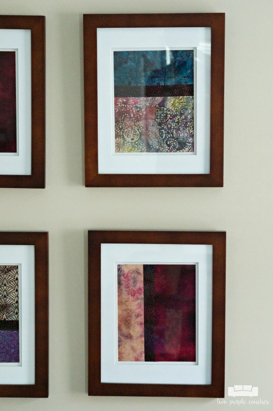 Detail of framed batik fabrics in this simple gallery wall master bedroom tour