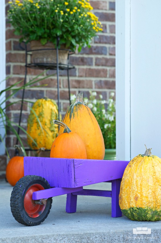 Fall porch decorating idea - Fill a vintage wheelbarrow with small pumpkins!