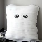 How to make a DIY Mummy Pillow. This pillow is the perfect not-so-spooky project for your Halloween home decor! And easy enough to make in an afternoon!