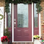 Create a festive holiday porch with these simple decorating ideas! All you need is some Garland, ornaments, evergreen and an easy DIY sign!