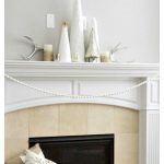 Transition your decor out of holiday mode with an elegant winter white mantel. Simple white trees paired with mercury glass create this beautiful style.