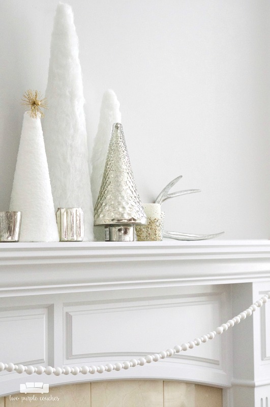 Simple trees and mercury glass create a beautiful "winter whites" mantel display