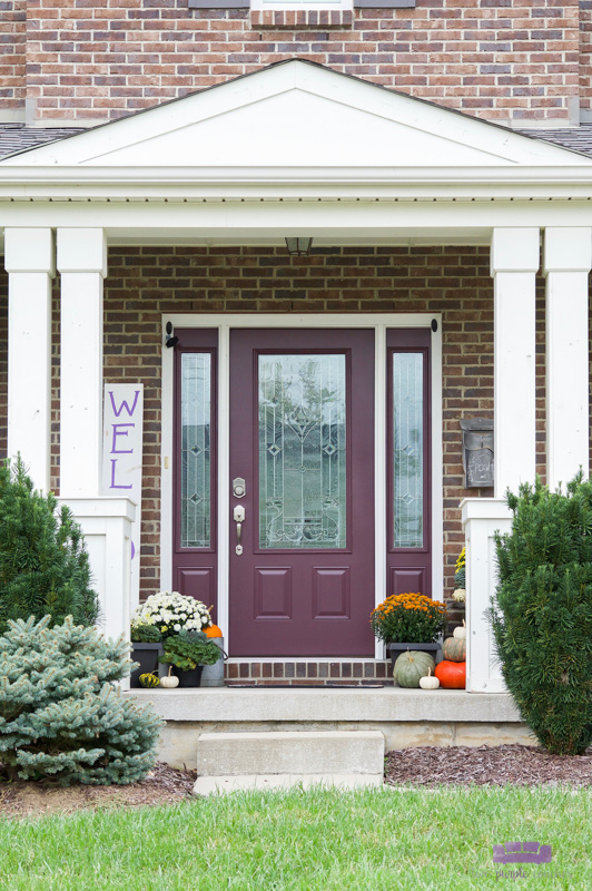 Outdoor porch decor with mums, pumpkins, and fall planters