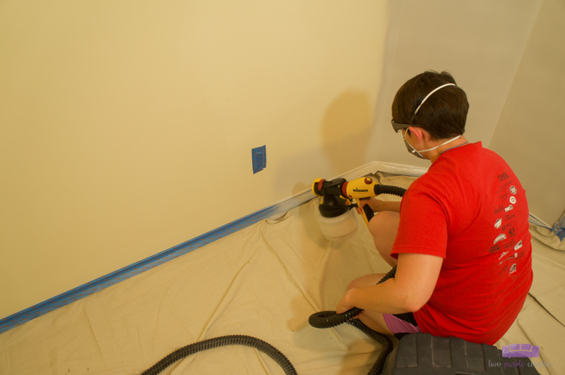 painting laundry room with paint sprayer
