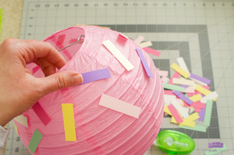 attaching sprinkles to paper lantern